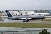 N667UA @ LAX - Smokey touchdown on RWY 7R for N667UA. - by Dean Heald