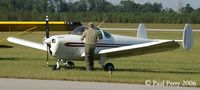 N3760H @ W03 - Securing the Ercoupe before taking in the sights - by Paul Perry