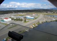 N4444Z @ LHD - 1958 DeHavilland BEAVER DHC-2 MK.1, P&W R-985 450 Hp, climbout over Lake Hood SPB. Note: Lake Hood Strip Z41 runway 13-31 2,200 X 75 gravel in upper background - by Doug Robertson
