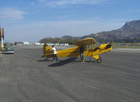 N33112 @ SZP - 1940 Piper J3C-65 CUB, Continental C90 90 Hp upgrade, Mom & son returning from a flight - by Doug Robertson