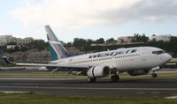 C-FCWJ @ TNCM - Westjet landing on runway 10 - by Daniel Jef
