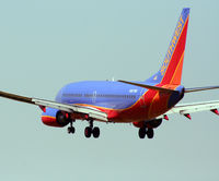N267WN @ KHOU - B737 drops below the fence line to touch down on 30L. - by Darryl Roach