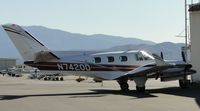 N7420D @ CNO - Parked by a hanger - by Helicopterfriend