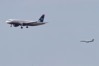 N119US @ KORD - US Airways Airbus A320-214, AWE799 arriving from KPHL on RWY 27L with Chautauqua/United Express CHQ5010 (in the background) arriving from KMLI on 27R at O'Hare. - by Mark Kalfas