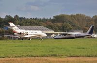 CS-DRZ @ EGHH - Engine running while G-RVRX taxies by - by John Coates