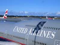 N128UA @ YSSY - United Airlines. 747-422. N128UA 8128 cn 30023 1245. Sister 744 Ship N105UA behind her. Sydney - Kingsford Smith International (Mascot) (SYD YSSY). Image © Brian McBride. 29 July 2004 - by Brian McBride
