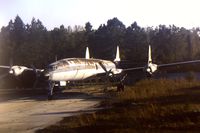 UNKNOWN @ SFB - Derelict Lockheed Constellation (unidentified) possibly used for training ground staff - parked at northern end on main runway SFB - as seen from departing flight.  Scanned from original slide - by Neil Henry