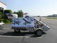 UNKNOWN @ SZP - Caravella Aerospace CaraVellair prototype roadable aircraft, side view with advertising banner, less folding wings and twin tail boom assembly. Will have airframe/aircraft parachute incorporated. - by Doug Robertson