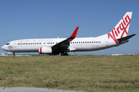 VH-VOQ @ YSSY - TAXI TO 34R - by Bill Mallinson