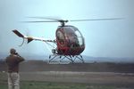 VH-GMD @ YMMB - Rare View of a Jayrow Hughes 269A helicopter (Cn 73-0258) hovering at the Jayrow Helicopter Base at Moorabbin YMMB on 14Jun1968. The helo was being photographed by several people while generating a cloud of dust. Someone looks too close for comfort. - by Walnaus47