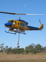 N234PH @ YBUD - Front Portside view of McDermott Aviation Bell 214B-1 Biglifter N234PH Cn 28050 hovering at Bundaberg Airshow at Bundaberg Airport YBUD on 17Jul2005. Equipped with ‘under-cabin’ water tank, with ‘pick-up’ hose extended.  Moon visible at rear. - by Walnaus47
