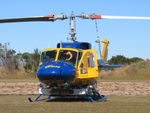 N234PH @ YBUD - Close cropped Front view of McDermott Aviation Bell 214B-1 Biglifter N234PH Cn 28050 parked at Bundaberg Airshow at Bundaberg Airport YBUD on 16Jul2005. Equipped with ‘under-cabin’ water tank, with ‘pick-up’ hose retracted. - by Walnaus47