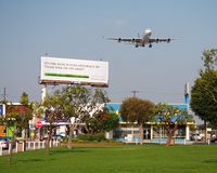  - Singapore Airlines 9V-SGC on short-final to RWY 24R as seen from the park across the street from In-N-Out Burger. - by Dean Heald