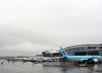  - South gates at Terminal D - Cold rainy day - Korean Air HL7751 at the gate along with the commuters - by Zane Adams