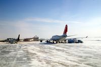  - Cold morning loading up NWA9980 with baggage from U of I football team.  10 degrees and 25-30 kt wind.  UPS 757 on the ramp - by Glenn E. Chatfield