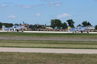  - Warbirds lining up to depart RWY 18 at Airventure 2011. - by Bob Simmermon