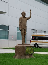  - Daniel Oduber Statue in between the New and Old Liberia Costa Rica Terminal Buildings  - by Mark Silvestri