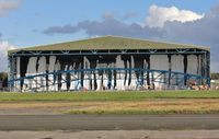  - Building screen for hangar extension shredded in violent storm - by John Coates