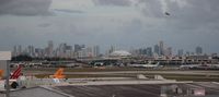  - Downtown Miami seen from the 11th floor of the Comfort Inn with Miami Airport's northeast ramp area.  Goodyear Blimp flying over Downtown.  Marlin's stadium also seen - by Florida Metal
