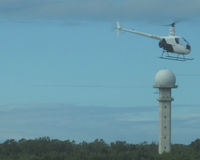  - helicopter ZS-RLU passing Tower, from Terminal building - by Neil Henry