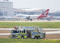  - DFW's finest with a Qantas 747 taxiing to its gate after landing.  - by paulp