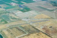  - Gustine around 2005. Looking to the north.The original runway paralleled  the hangars and was much shorter.The gas island is on the west end of the old runway. - by S B J