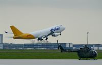  - German Army heli on visit at apron 1 while large DHL equipment is leaving on rwy 26L for a long term ride westbound.... - by Holger Zengler