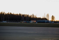  - View of private aeroplanes parked in front of flying club offices. - by Remi Farvacque
