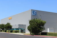  - SUN AIR JETS, a 24/7 operation. One of their large hangars with recent new logo. - by Doug Robertson