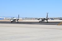  - Two Islanders parked on the back country ramp (Gate 58) awaiting passengers. - by Gerald Howard