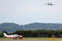  - Apron view at Dundee Riverside EGPN. A based PA-28 waits whilst a visiting Mooney from Germany is on finals - by Clive Pattle