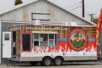  - Various food truck contractors are invited to feed the Aviation Museum crowds in addition to the open airport restaurant. This is a typical portable food truck setting up early on site. - by Doug Robertson