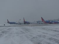  - 3 Southwest jets getting a second de ice before take off. - by Gerald Howard