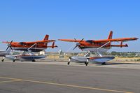  - Two Quest Kodiak 100s belonging to the Fish & Wildlife Service, U.S. Dept. of the Interior parked for maintenance. - by Gerald Howard