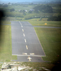  - Short finals for 32 St Marys Isles of Scilly in Twin Otter G-CEWM.  Since my 1987 pictures (qv) the grass has been replaced by tarmac runway.  The slope here is quite apparent, see also the shots at ground level from the threshold. - by Pete Hughes