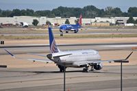  - United Express taxies out for RWY 10L while Sun Country takes off on RWY 10R. - by Gerald Howard