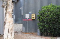  - EMERGENCY SHUTDOWN for the SZP Fuel Dock, location- on adjacent hangar rear wall about 60 feet west of the Fuel Dock. - by Doug Robertson
