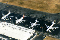  @ Brisbane International Airport - APOV of 'Old Eagle Farm' International Airport YBBN on 12Aug1992. The line-up on the ramp (from front right to left) is a JAL Super Resort Express B747-246B, an Air New Zealand B767, a Qantas B747-338, and a British Airways B747-436.
 - by Walnaus47